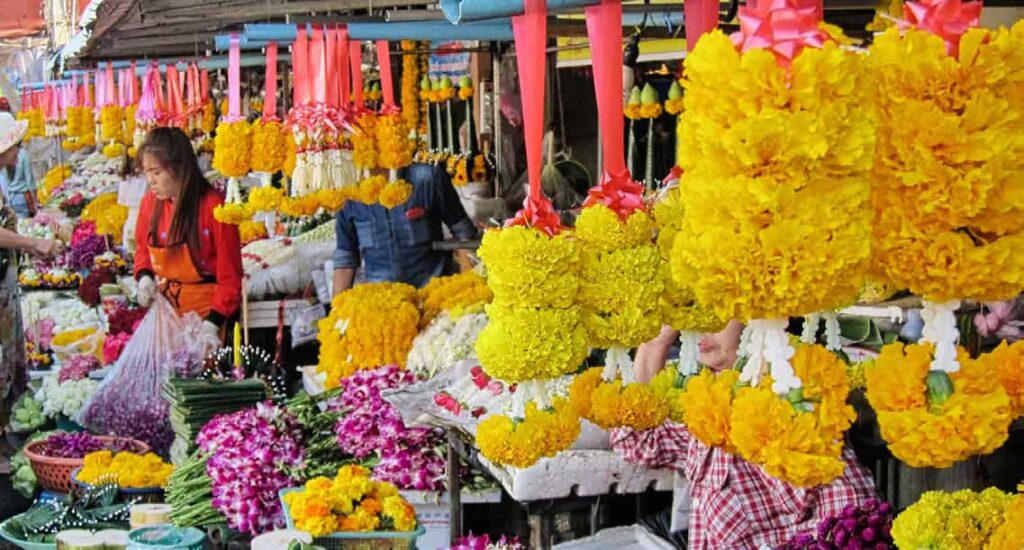 Stall of colorful flowers at a Thai market.