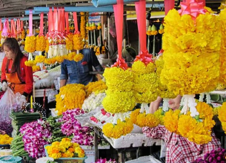 Stall of colorful flowers at a Thai market.